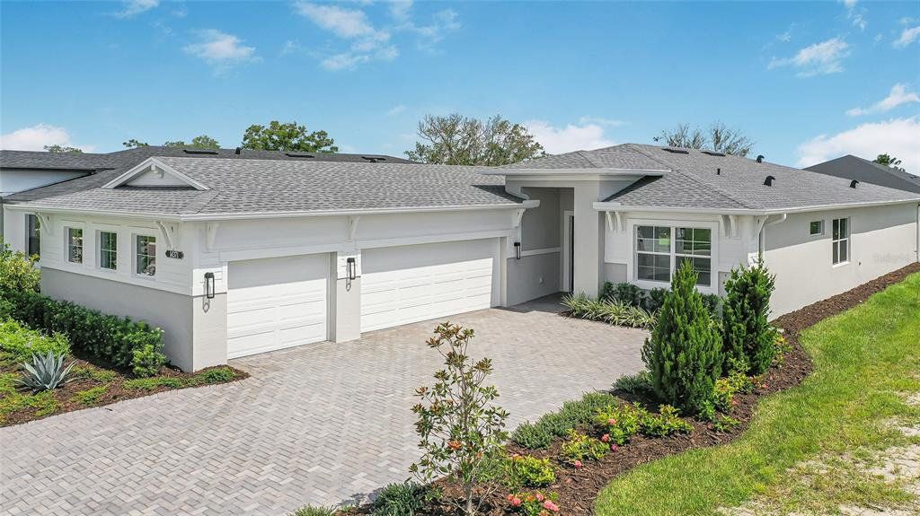 Front exterior of a new home in Woodland Preserve, Parrish, FL, highlighting curb appeal (Image 1). Front exterior of a new home in Woodland Preserve, Parrish, FL, highlighting curb appeal (Image 1).