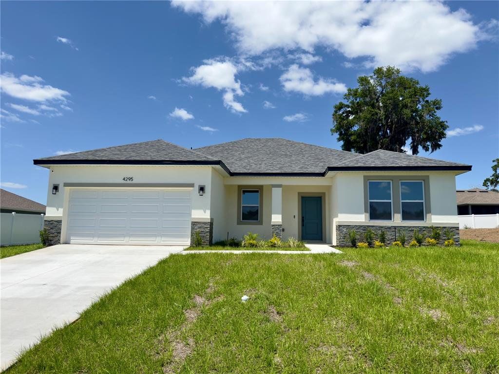 Front exterior of a new home in , Ocala, FL, highlighting curb appeal (Image 1). Front exterior of a new home in , Ocala, FL, highlighting curb appeal (Image 1).
