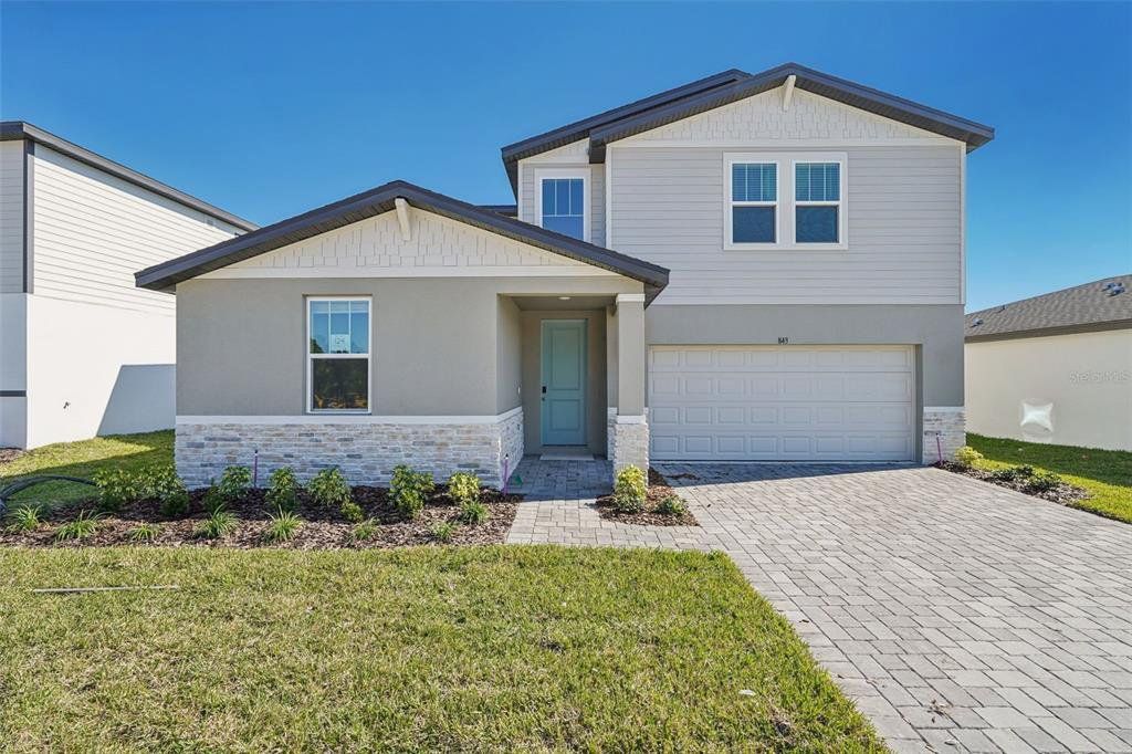 Front exterior of a new home in The Reserve at Hammock Oaks - Signature Series, Lady Lake, FL, highlighting curb appeal (Image 1). Front exterior of a new home in The Reserve at Hammock Oaks - Signature Series, Lady Lake, FL, highlighting curb appeal (Image 1).