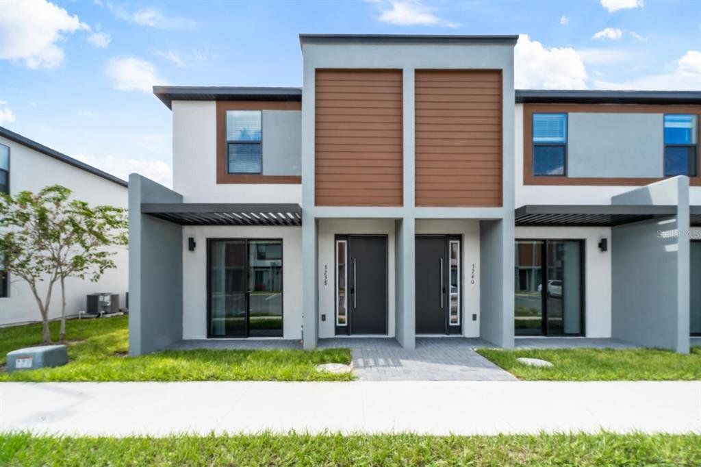 Front exterior of a new home in The Hub at Westside, Kissimmee, FL, highlighting curb appeal (Image 1). Front exterior of a new home in The Hub at Westside, Kissimmee, FL, highlighting curb appeal (Image 1).