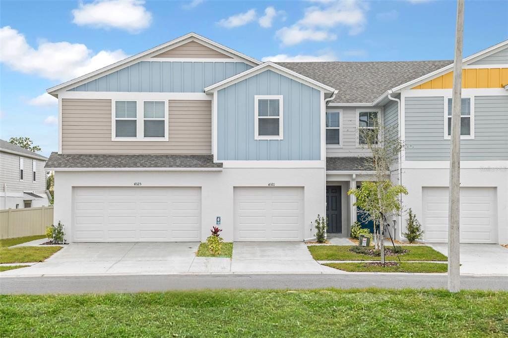 Front exterior of a new home in Grove at Crosswind, Haines City, FL, highlighting curb appeal (Image 1).