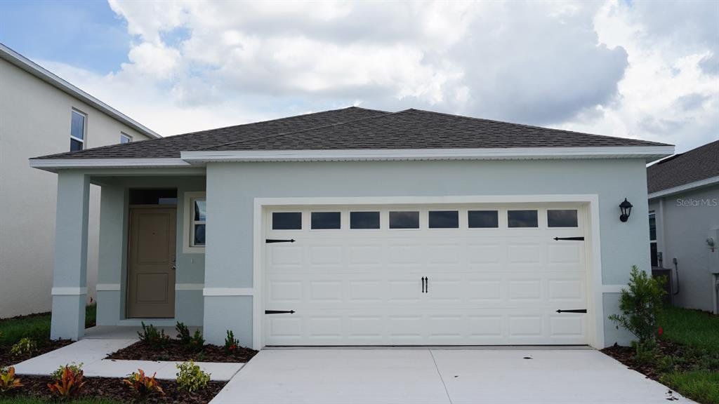 Front exterior of a new home in Harmony at Lake Eloise, Winter Haven, FL, highlighting curb appeal (Image 1). Front exterior of a new home in Harmony at Lake Eloise, Winter Haven, FL, highlighting curb appeal (Image 1).