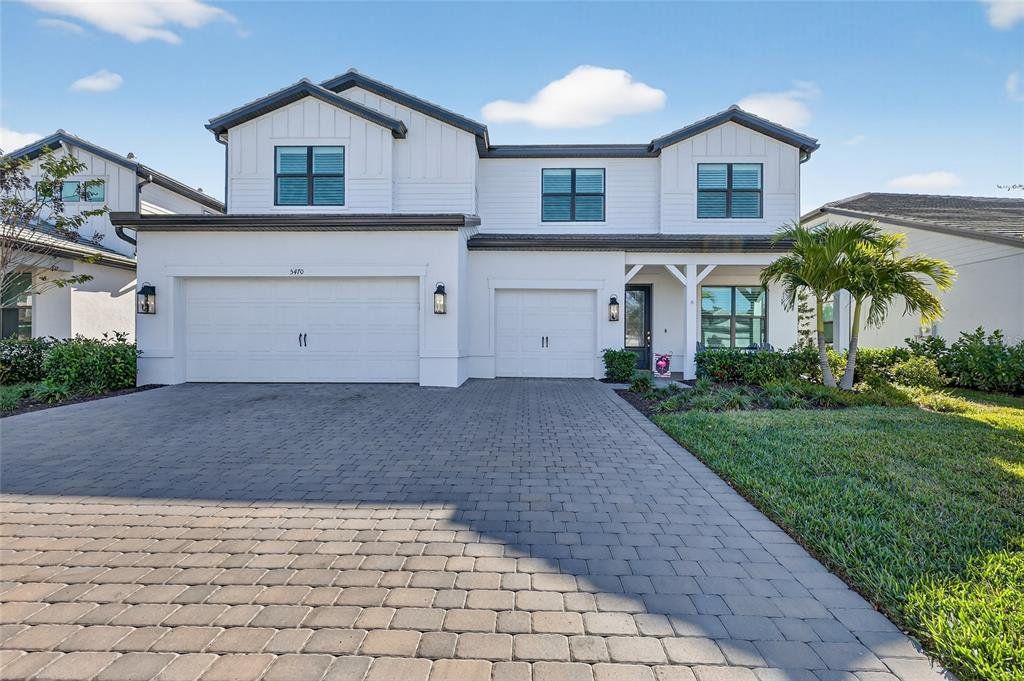 Front exterior of a new home in , Lakewood Ranch, FL, highlighting curb appeal (Image 1). Front exterior of a new home in , Lakewood Ranch, FL, highlighting curb appeal (Image 1).