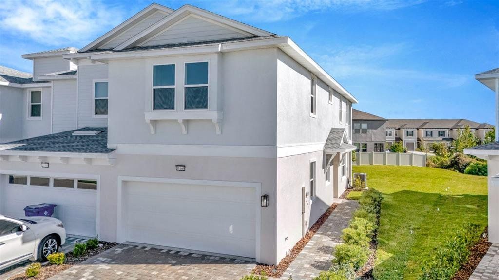 Front exterior of a new home in Lagoon Residences at Epperson, Wesley Chapel, FL, highlighting curb appeal (Image 1). Front exterior of a new home in Lagoon Residences at Epperson, Wesley Chapel, FL, highlighting curb appeal (Image 1).