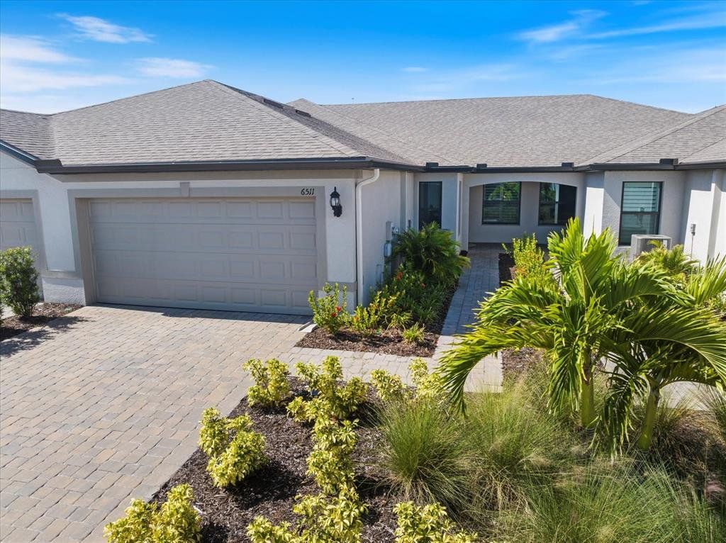 Front exterior of a new home in , Sarasota, FL, highlighting curb appeal (Image 1). Front exterior of a new home in , Sarasota, FL, highlighting curb appeal (Image 1).