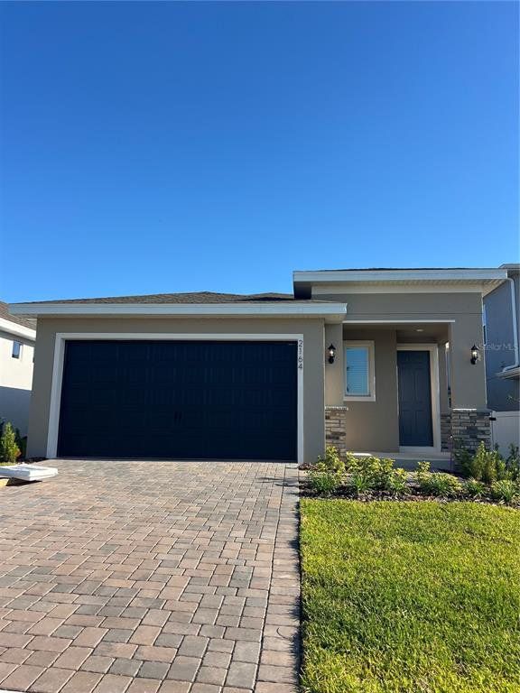 Front exterior of a new home in Hills of Minneola, Minneola, FL, highlighting curb appeal (Image 1). Front exterior of a new home in Hills of Minneola, Minneola, FL, highlighting curb appeal (Image 1).