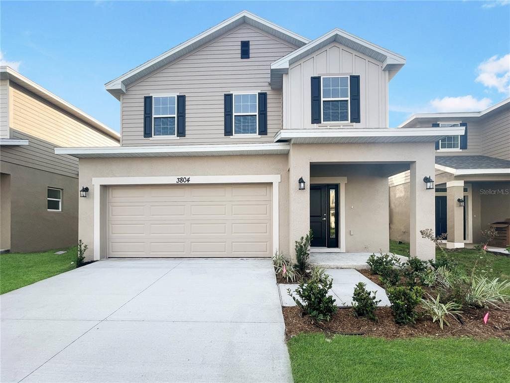 Front exterior of a new home in Harmony Central, St. Cloud, FL, highlighting curb appeal (Image 1).
