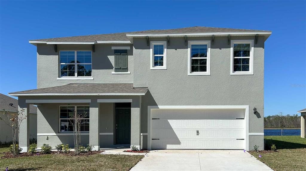 Front exterior of a new home in Gardenside at Ormond Station, Ormond Beach, FL, highlighting curb appeal (Image 1).