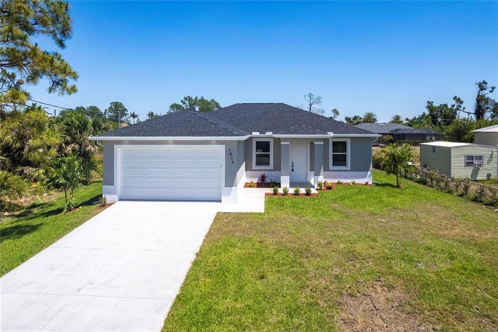 Front exterior of a new home in , North Port, FL, highlighting curb appeal (Image 1). Front exterior of a new home in , North Port, FL, highlighting curb appeal (Image 1).