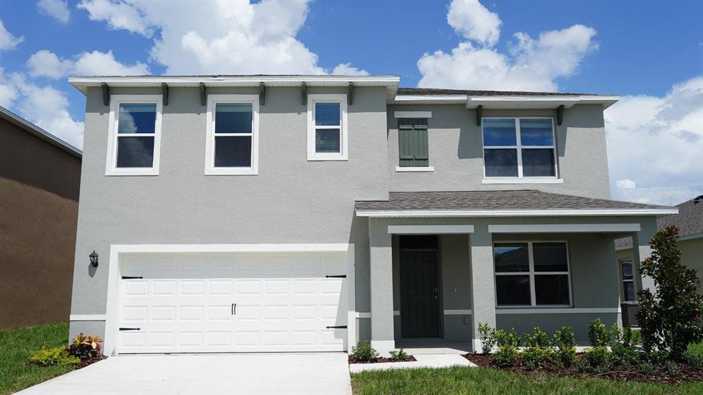 Front exterior of a new home in Cascades, Davenport, FL, highlighting curb appeal (Image 1). Front exterior of a new home in Cascades, Davenport, FL, highlighting curb appeal (Image 1).