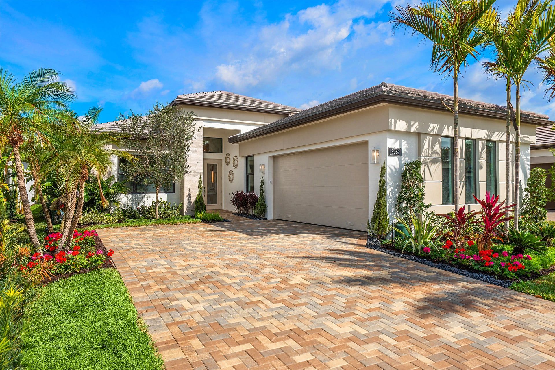 Front exterior of a new home in Valencia Del Mar (55+), Boynton Beach, FL, highlighting curb appeal (Image 1). Front exterior of a new home in Valencia Del Mar (55+), Boynton Beach, FL, highlighting curb appeal (Image 1).