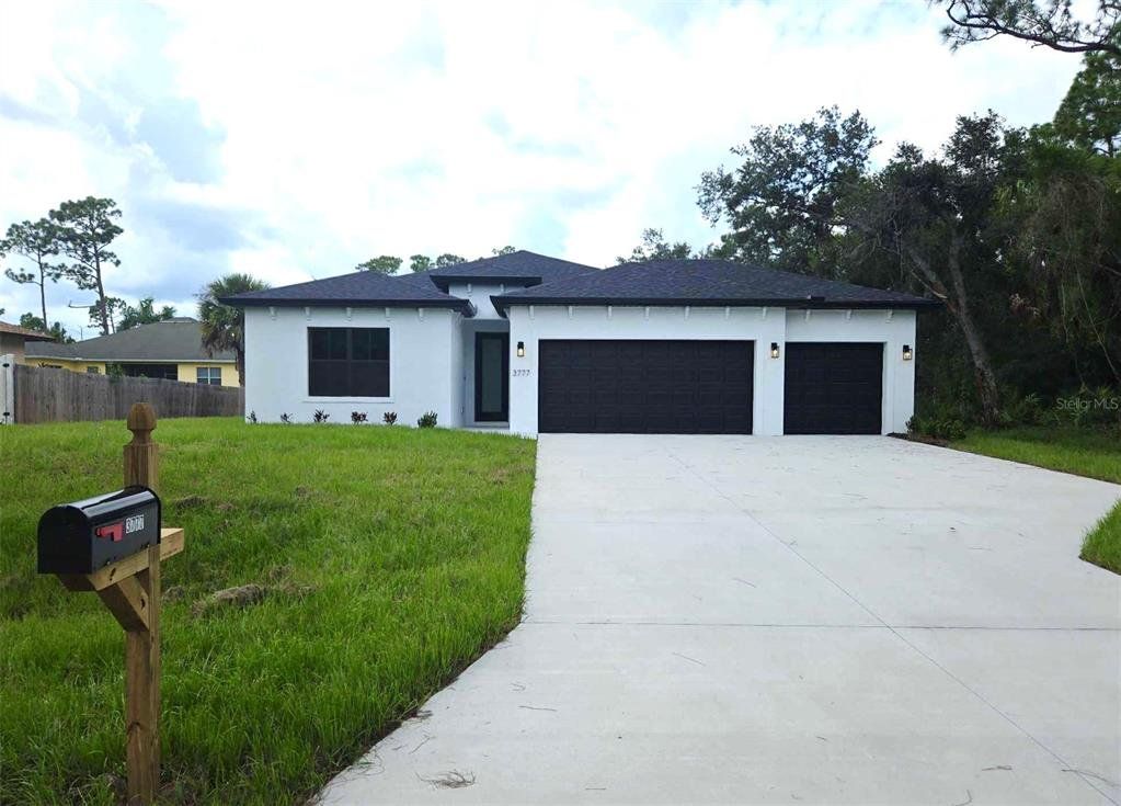Front exterior of a new home in , North Port, FL, highlighting curb appeal (Image 1). Front exterior of a new home in , North Port, FL, highlighting curb appeal (Image 1).
