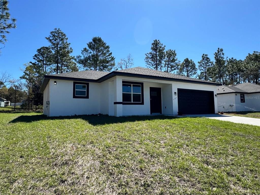 Front exterior of a new home in , Citrus Springs, FL, highlighting curb appeal (Image 1). Front exterior of a new home in , Citrus Springs, FL, highlighting curb appeal (Image 1).