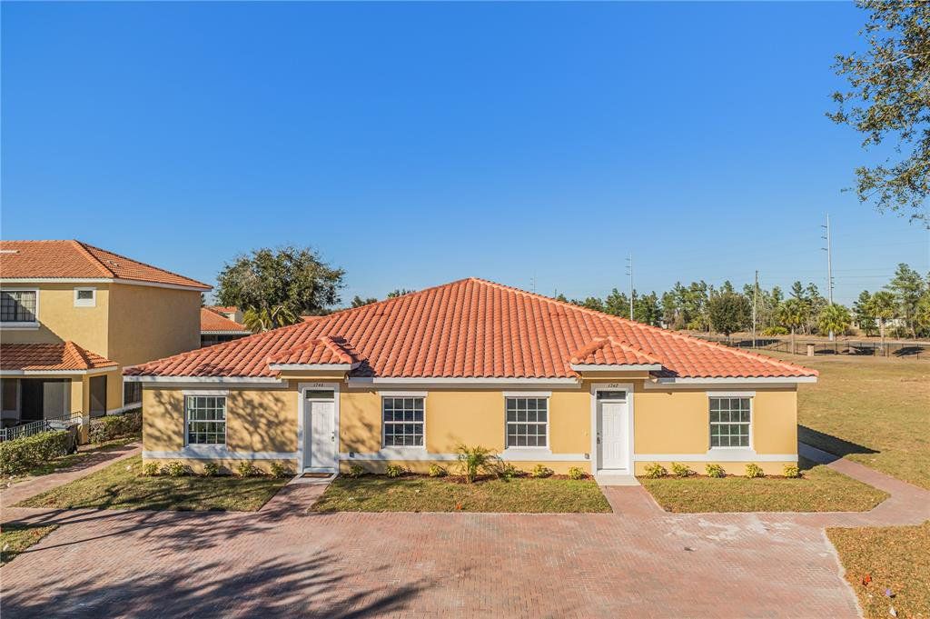 Front exterior of a new home in Tuscany Preserve, Kissimmee, FL, highlighting curb appeal (Image 1). Front exterior of a new home in Tuscany Preserve, Kissimmee, FL, highlighting curb appeal (Image 1).
