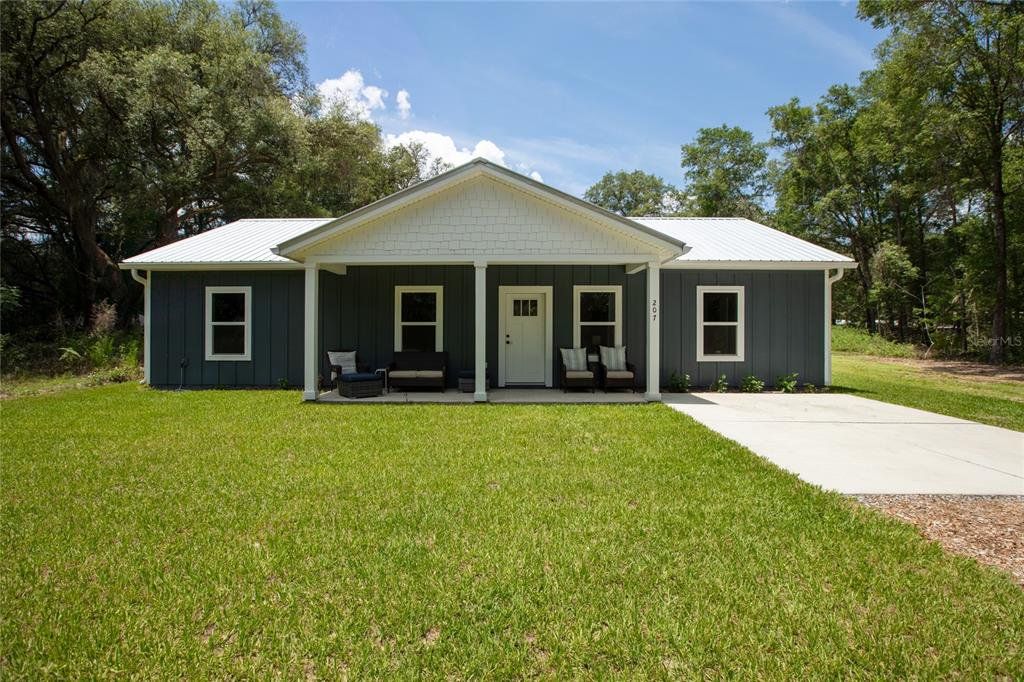 Front exterior of a new home in , Florahome, FL, highlighting curb appeal (Image 1). Front exterior of a new home in , Florahome, FL, highlighting curb appeal (Image 1).