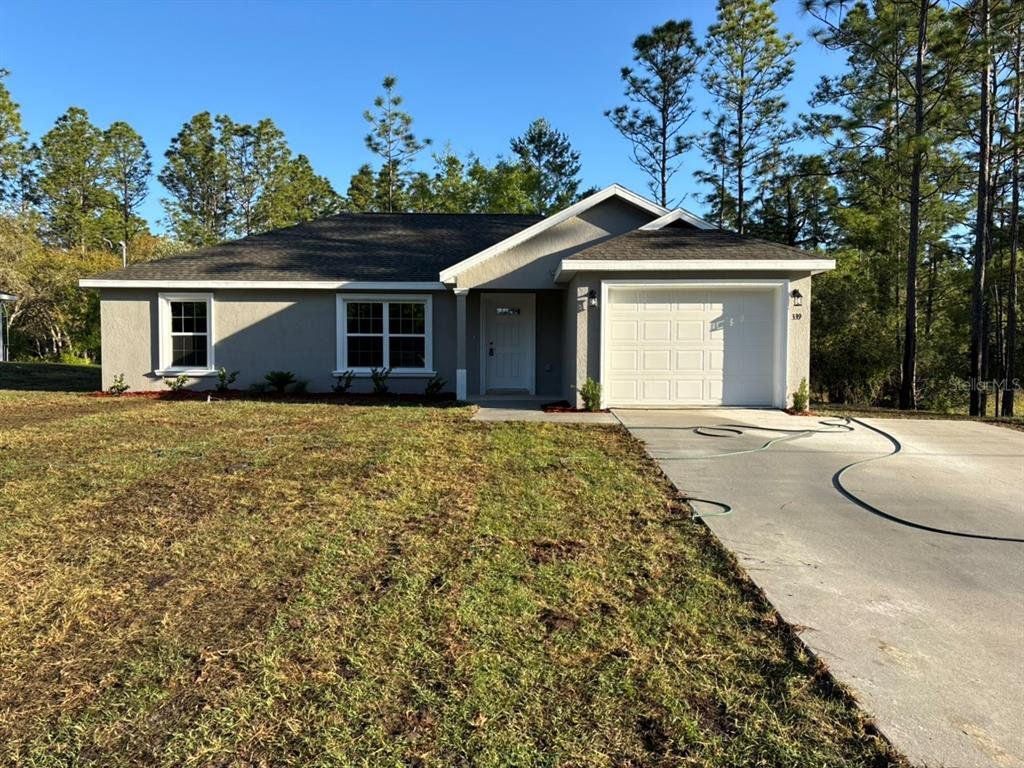 Front exterior of a new home in , Dunnellon, FL, highlighting curb appeal (Image 1). Front exterior of a new home in , Dunnellon, FL, highlighting curb appeal (Image 1).