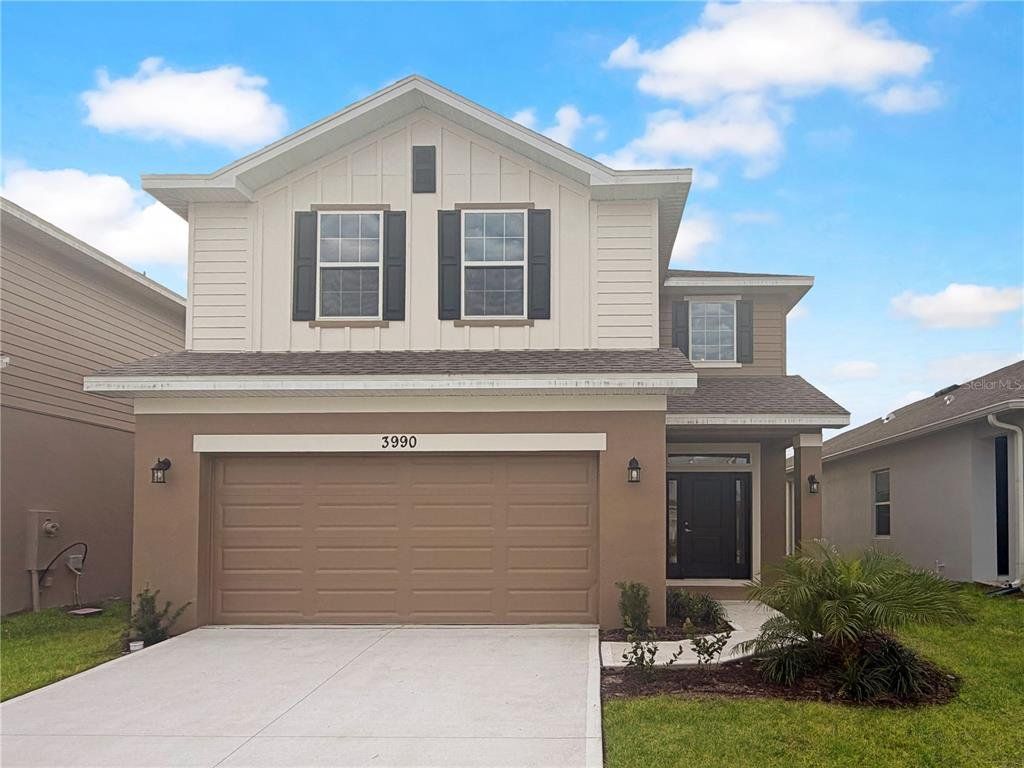 Front exterior of a new home in Harmony Central, St. Cloud, FL, highlighting curb appeal (Image 1). Front exterior of a new home in Harmony Central, St. Cloud, FL, highlighting curb appeal (Image 1).