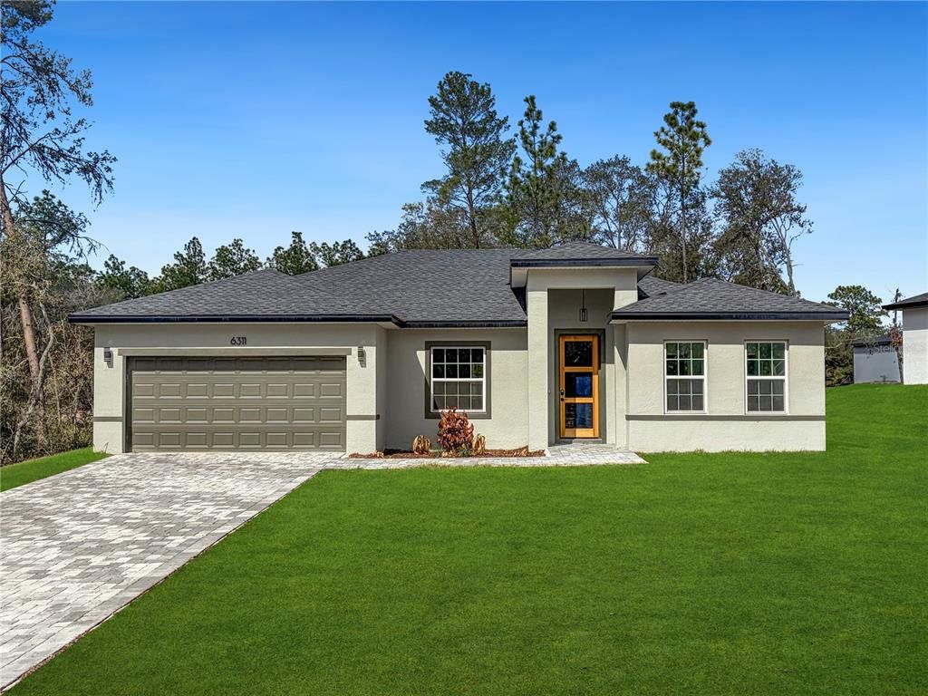 Front exterior of a new home in , Dunnellon, FL, highlighting curb appeal (Image 1). Front exterior of a new home in , Dunnellon, FL, highlighting curb appeal (Image 1).