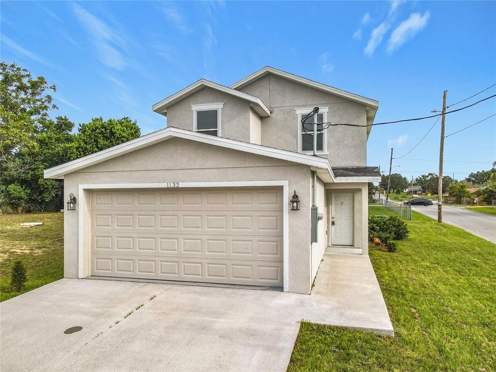Front exterior of a new home in , Haines City, FL, highlighting curb appeal (Image 1). Front exterior of a new home in , Haines City, FL, highlighting curb appeal (Image 1).