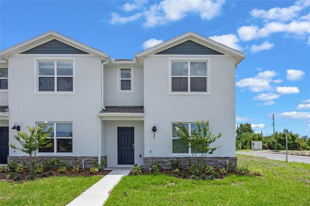 Front exterior of a new home in , St. Cloud, FL, highlighting curb appeal (Image 1).