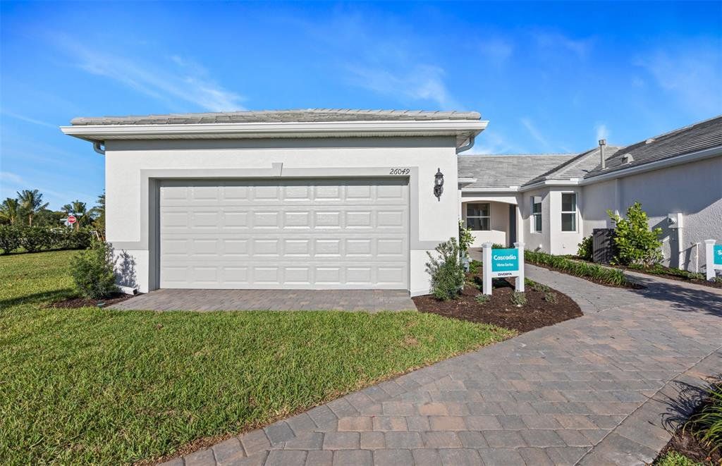 Front exterior of a new home in BeachWalk by Manasota Key, Englewood, FL, highlighting curb appeal (Image 1). Front exterior of a new home in BeachWalk by Manasota Key, Englewood, FL, highlighting curb appeal (Image 1).
