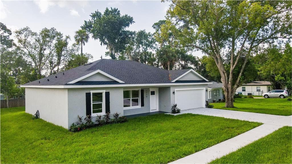 Front exterior of a new home in , Deltona, FL, highlighting curb appeal (Image 1). Front exterior of a new home in , Deltona, FL, highlighting curb appeal (Image 1).