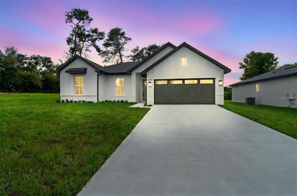 Front exterior of a new home in , Orange City, FL, highlighting curb appeal (Image 1). Front exterior of a new home in , Orange City, FL, highlighting curb appeal (Image 1).