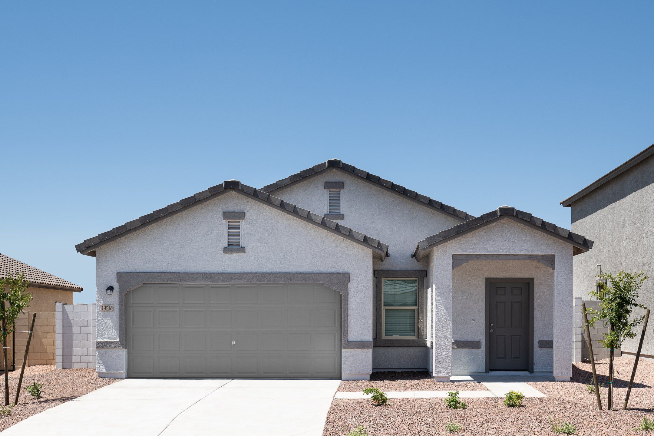 Front exterior of a new home in Villages at Accomazzo, Tolleson, AZ, highlighting curb appeal (Image 1). Front exterior of a new home in Villages at Accomazzo, Tolleson, AZ, highlighting curb appeal (Image 1).