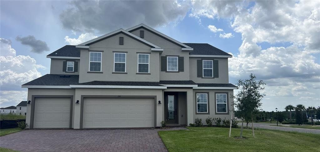 Front exterior of a new home in Trinity Lakes, Groveland, FL, highlighting curb appeal (Image 1). Front exterior of a new home in Trinity Lakes, Groveland, FL, highlighting curb appeal (Image 1).