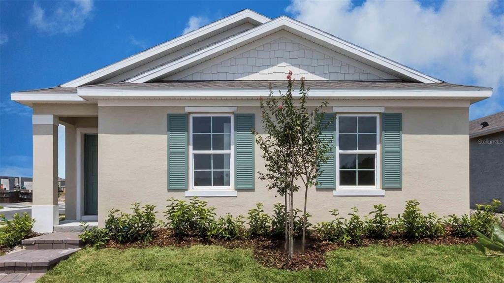 Front exterior of a new home in Crossroads at Kelly Park, Apopka, FL, highlighting curb appeal (Image 1). Front exterior of a new home in Crossroads at Kelly Park, Apopka, FL, highlighting curb appeal (Image 1).