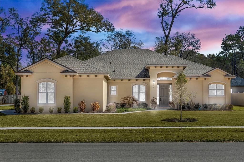 Front exterior of a new home in , Orange City, FL, highlighting curb appeal (Image 1). Front exterior of a new home in , Orange City, FL, highlighting curb appeal (Image 1).
