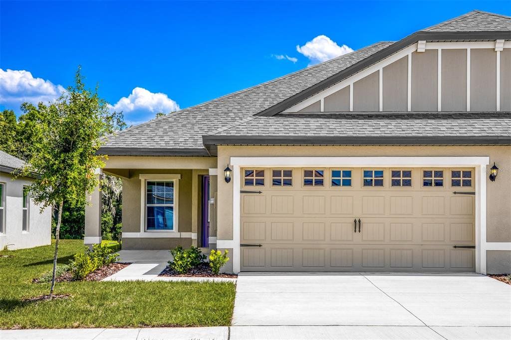 Front exterior of a new home in Gum Lake Preserve, Lake Alfred, FL, highlighting curb appeal (Image 1). Front exterior of a new home in Gum Lake Preserve, Lake Alfred, FL, highlighting curb appeal (Image 1).