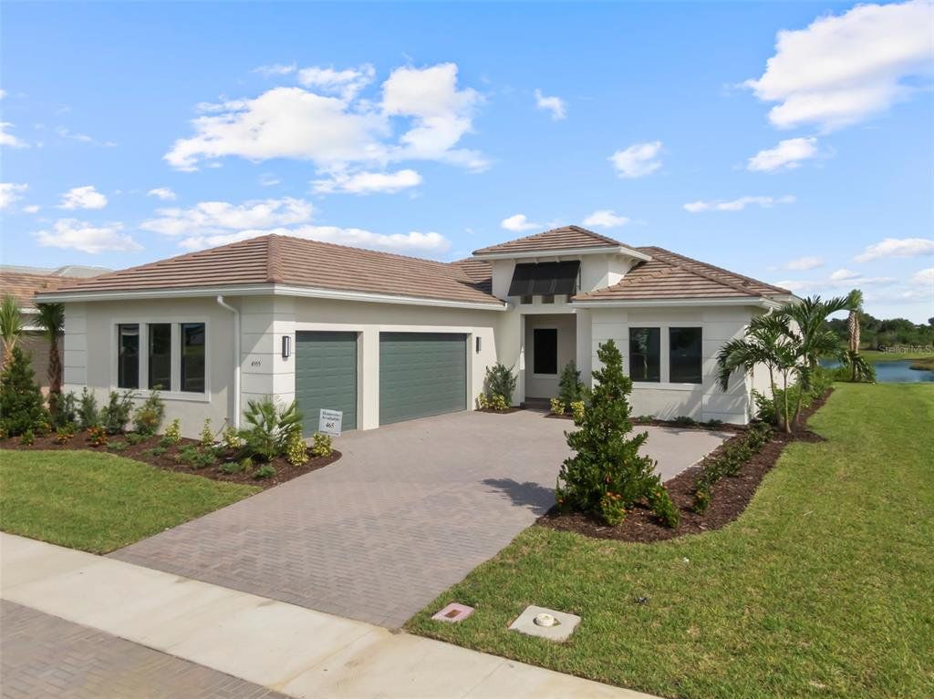 Front exterior of a new home in Artistry Sarasota, Sarasota, FL, highlighting curb appeal (Image 1).