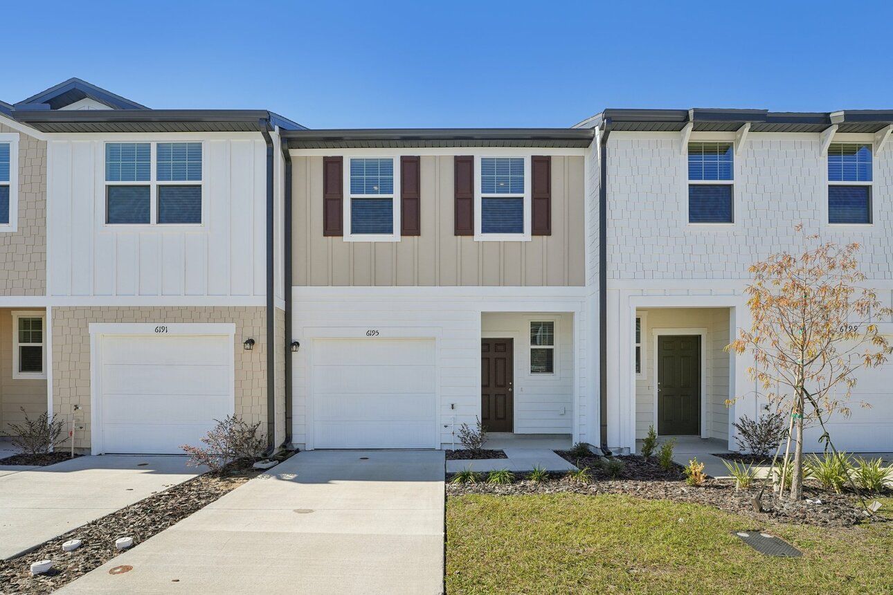 Front exterior of a new home in Clinton Townhomes, Dade City, FL, highlighting curb appeal (Image 1). Front exterior of a new home in Clinton Townhomes, Dade City, FL, highlighting curb appeal (Image 1).