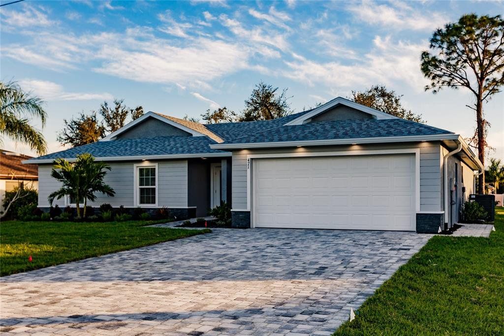 Front exterior of a new home in , Punta Gorda, FL, highlighting curb appeal (Image 1).