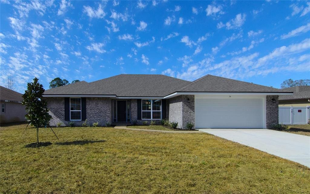Front exterior of a new home in Palm Coast, Palm Coast, FL, highlighting curb appeal (Image 1). Front exterior of a new home in Palm Coast, Palm Coast, FL, highlighting curb appeal (Image 1).