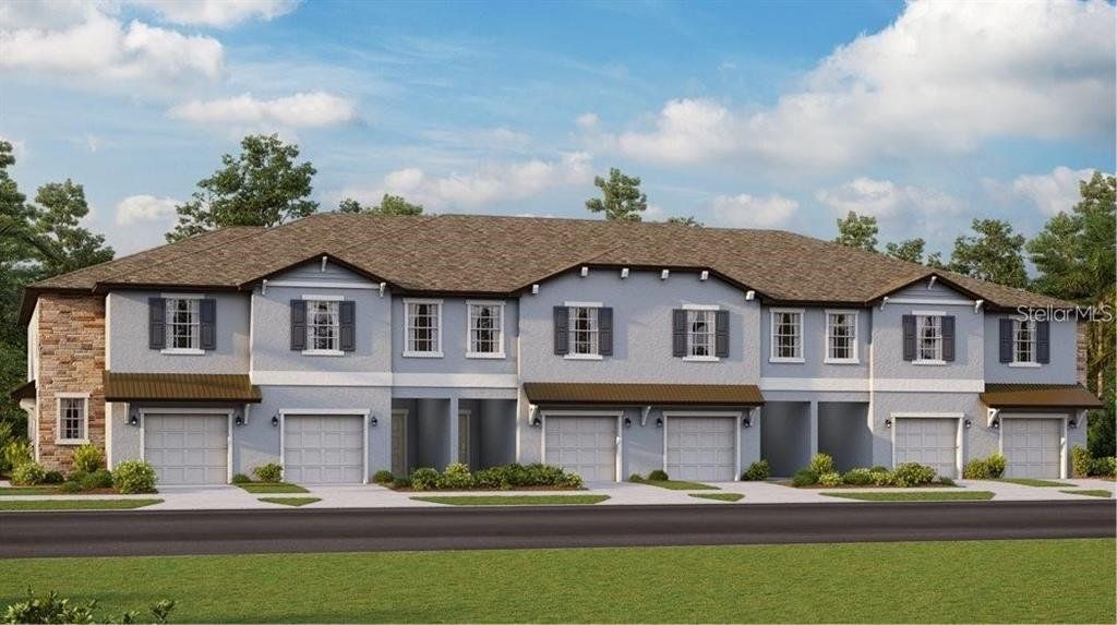 Front exterior of a new home in , Land O' Lakes, FL, highlighting curb appeal (Image 1).