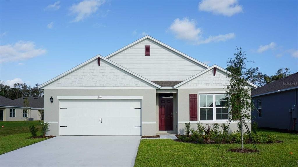 Front exterior of a new home in Oak Leaf Preserve, New Smyrna Beach, FL, highlighting curb appeal (Image 1). Front exterior of a new home in Oak Leaf Preserve, New Smyrna Beach, FL, highlighting curb appeal (Image 1).