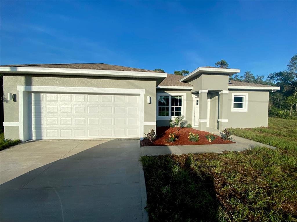 Front exterior of a new home in , Citrus Springs, FL, highlighting curb appeal (Image 1).