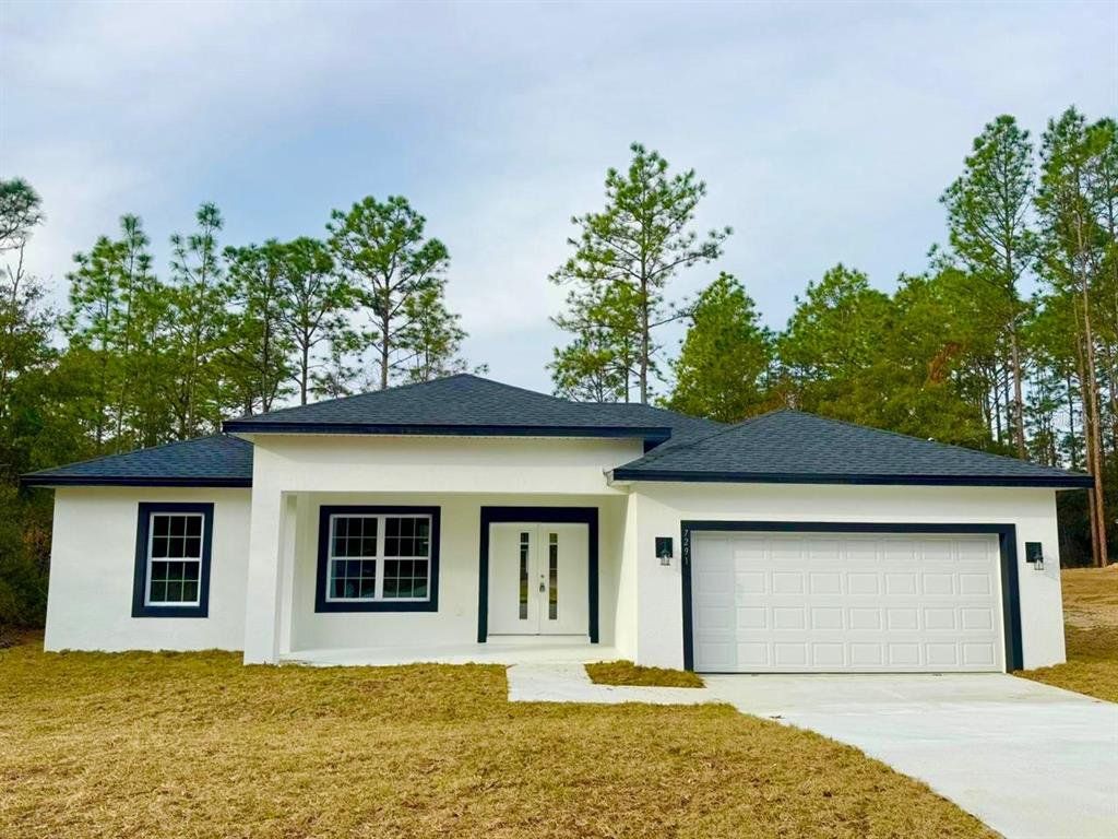 Front exterior of a new home in , Citrus Springs, FL, highlighting curb appeal (Image 1).