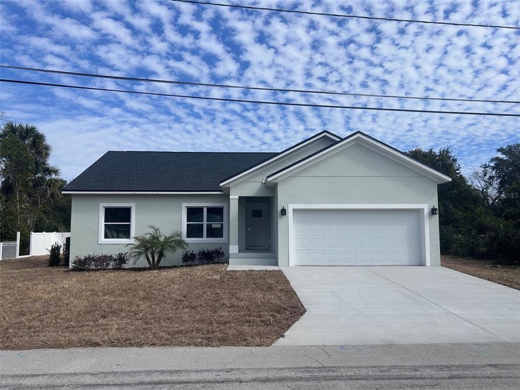 Front exterior of a new home in , New Smyrna Beach, FL, highlighting curb appeal (Image 1). Front exterior of a new home in , New Smyrna Beach, FL, highlighting curb appeal (Image 1).