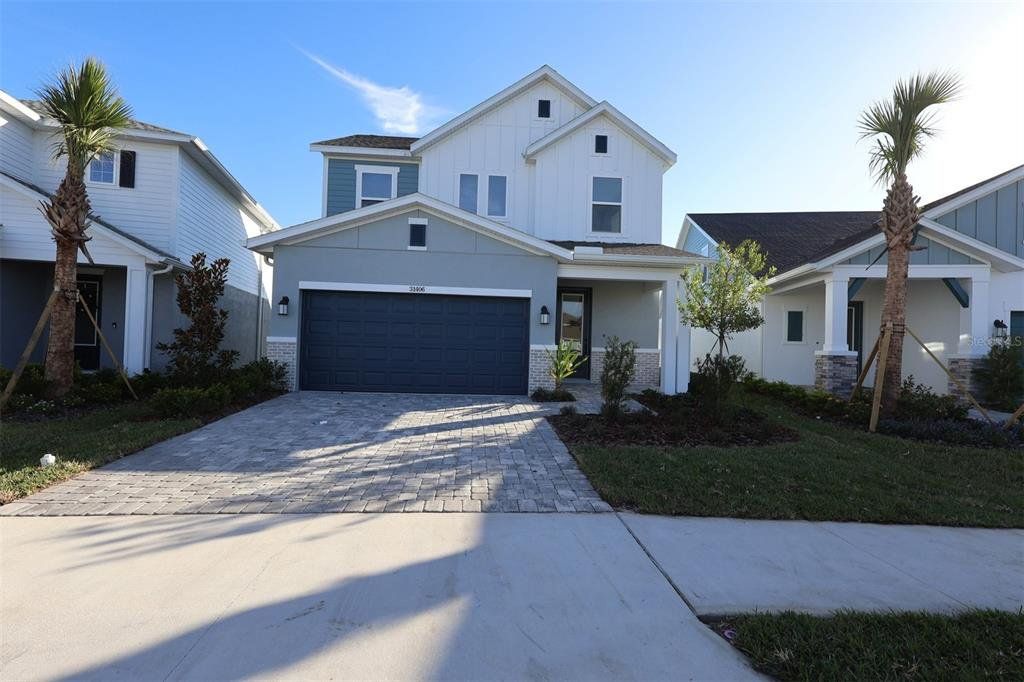 Front exterior of a new home in Chapel Crossings - Garden Series, Wesley Chapel, FL, highlighting curb appeal (Image 1). Front exterior of a new home in Chapel Crossings - Garden Series, Wesley Chapel, FL, highlighting curb appeal (Image 1).