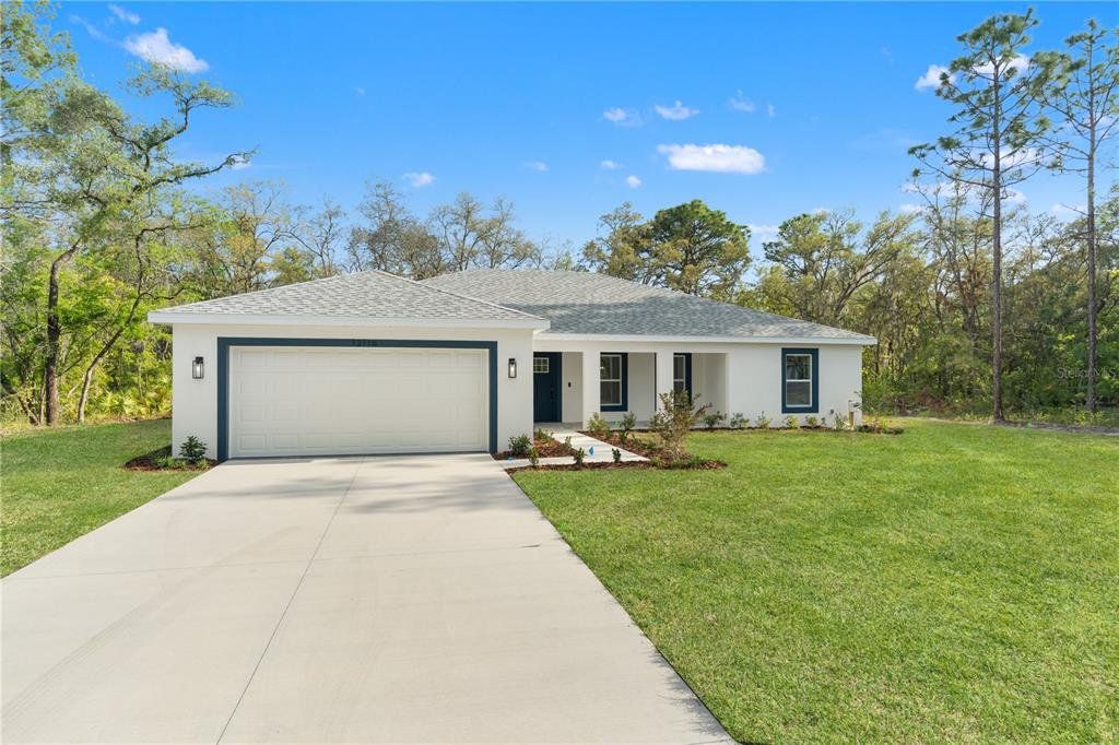 Front exterior of a new home in , Weeki Wachee, FL, highlighting curb appeal (Image 1). Front exterior of a new home in , Weeki Wachee, FL, highlighting curb appeal (Image 1).