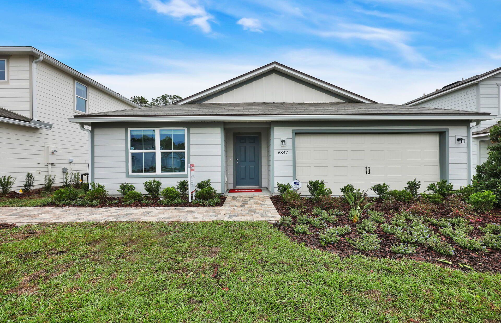 Front exterior of a new home in Wells Landing, Jacksonville, FL, highlighting curb appeal (Image 1).
