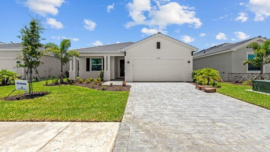 Front exterior of a new home in , Englewood, FL, highlighting curb appeal (Image 1).
