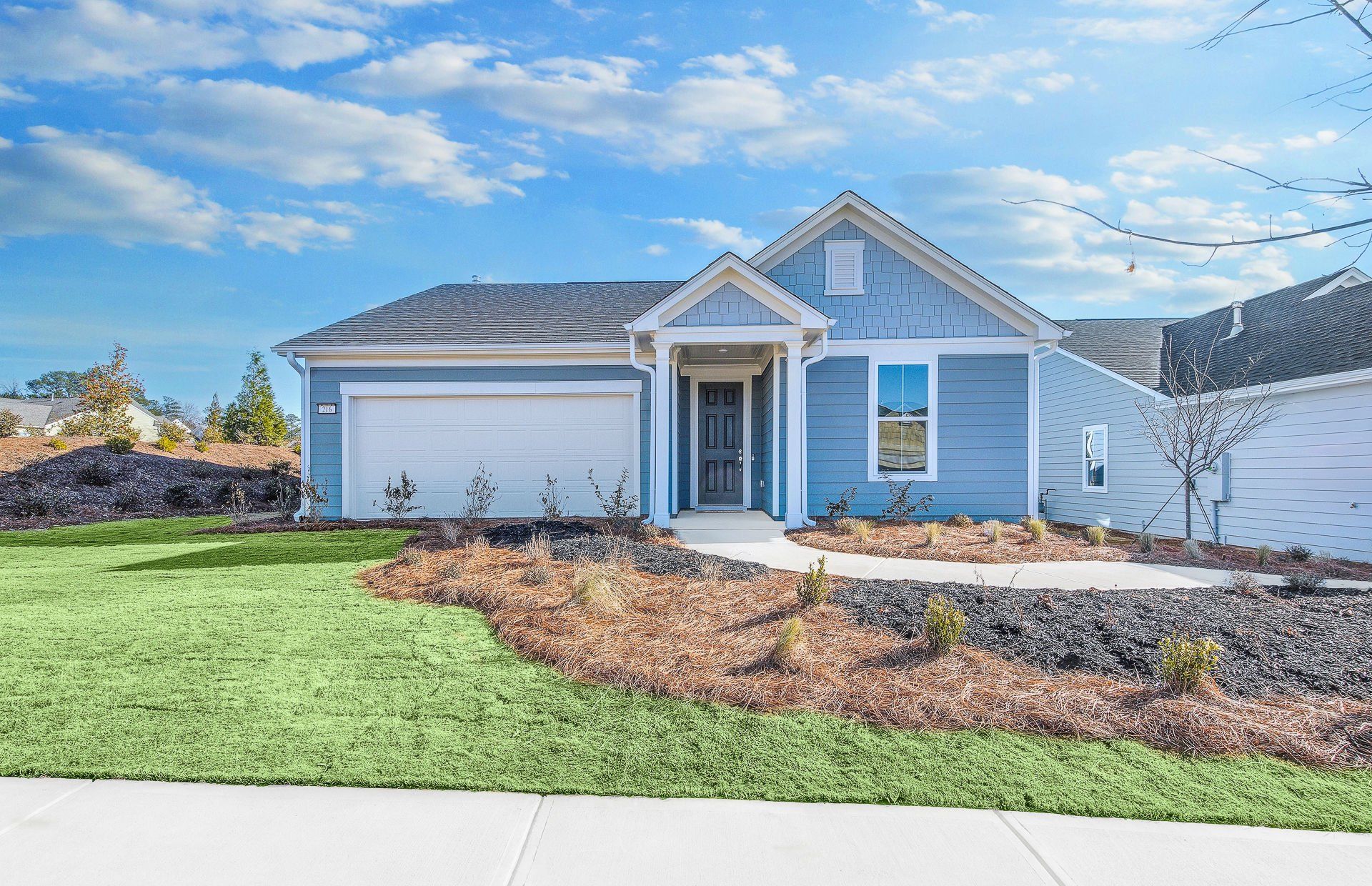 Exterior details and patio area of a home in Sun City Peachtree, Griffin (Image 1).