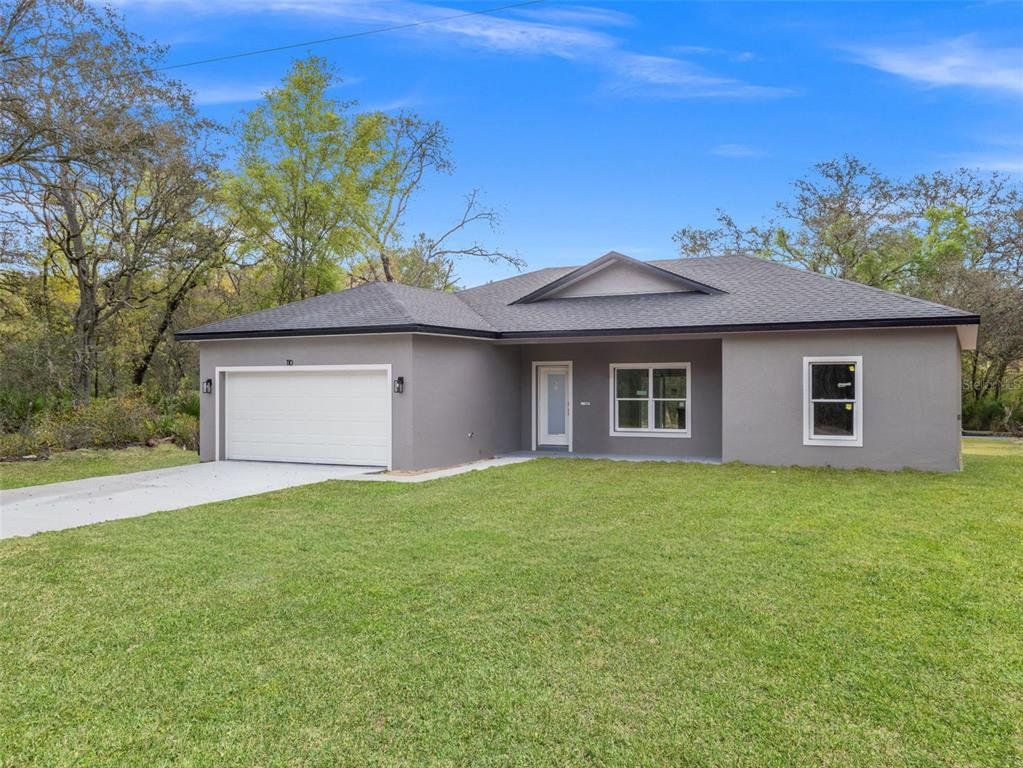 Front exterior of a new home in , Ocklawaha, FL, highlighting curb appeal (Image 1). Front exterior of a new home in , Ocklawaha, FL, highlighting curb appeal (Image 1).