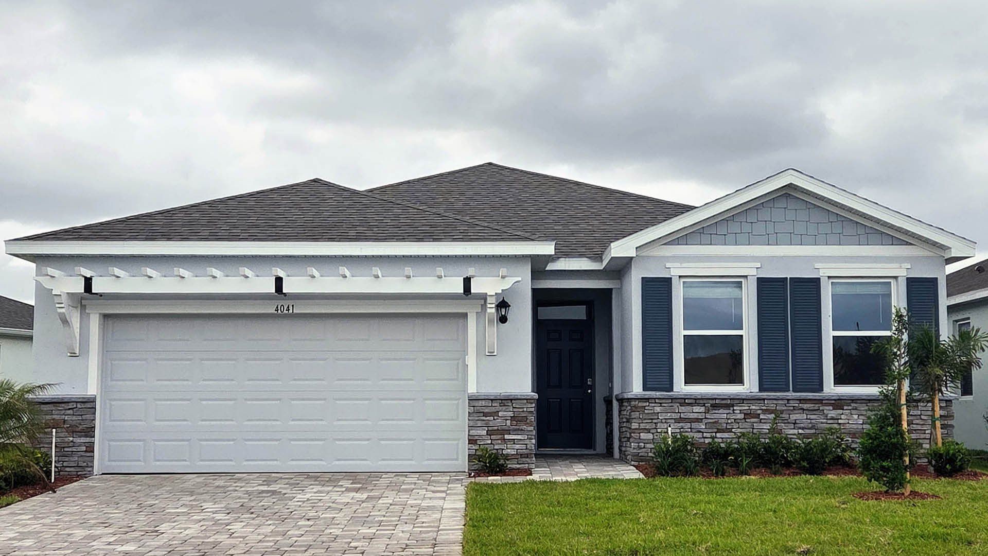 Front exterior of a new home in Cypress Bay West, Palm Bay, FL, highlighting curb appeal (Image 1). Front exterior of a new home in Cypress Bay West, Palm Bay, FL, highlighting curb appeal (Image 1).