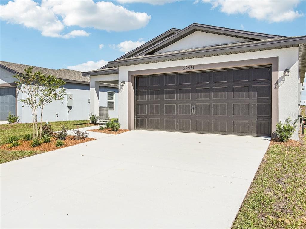 Front exterior of a new home in Fulton Meadows, Lakeland, FL, highlighting curb appeal (Image 1). Front exterior of a new home in Fulton Meadows, Lakeland, FL, highlighting curb appeal (Image 1).