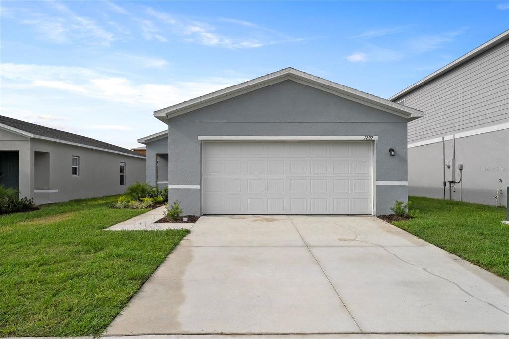Front exterior of a new home in Eagle Hammock, Eagle Lake, FL, highlighting curb appeal (Image 1). Front exterior of a new home in Eagle Hammock, Eagle Lake, FL, highlighting curb appeal (Image 1).